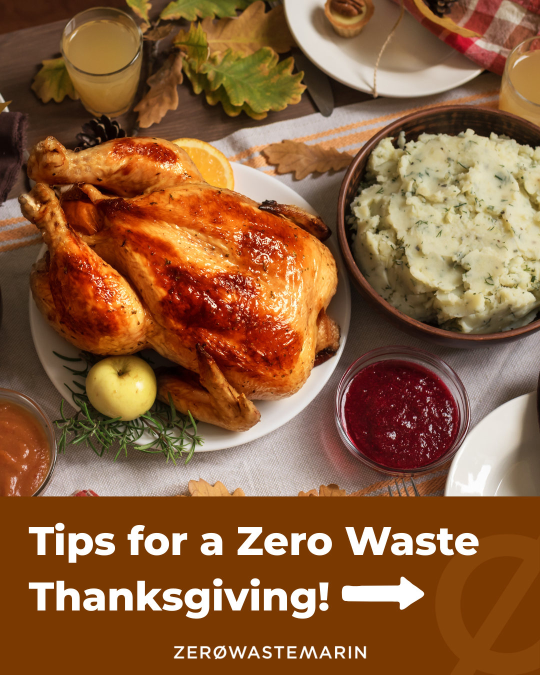 A Thanksgiving dinner table with an array of food surrounded by fall leaves and decorations,  text o