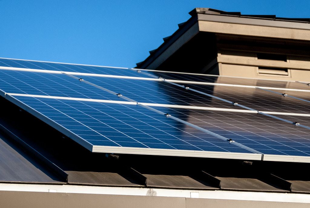 Close up of solar panels on a brown roof on a sunny clear day