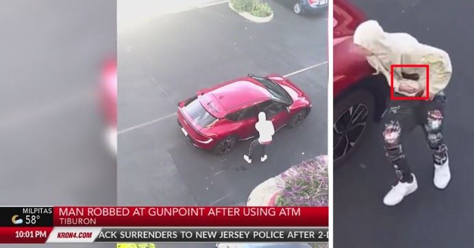 image shows a young man getting into a red car, concealing something in his yellow hoodie sweatshirt